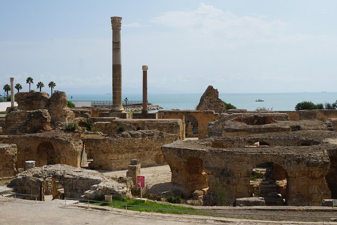 Guided Bike Tour of Carthage Archeological Site in Tunisia - Stop 3: Baths of Antoninus, long Roman architecture with sea-facing ruins